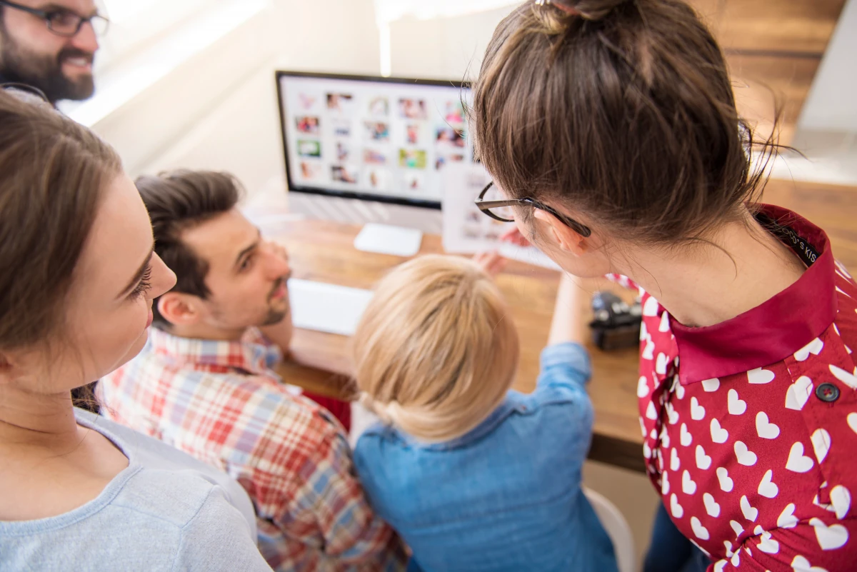 People collaborating around a computer
